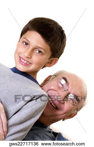 Portrait of a grandfather hugging his grandson View Large Photo Image Stock Photograph - Portrait of a grandfather hugging his grandson. Fotosearch