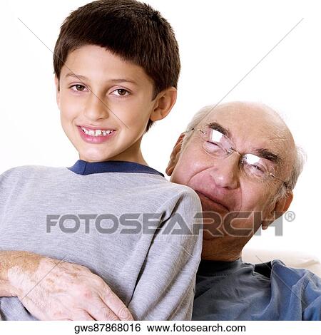 Stock Photograph - Portrait of a grandfather hugging his grandson. Fotosearch
