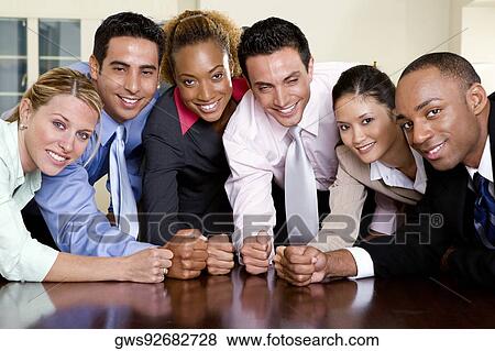 Portrait of a group of business executives with their fists on a table View Large Photo Image Stock Photo - Portrait of a group of business executives with their fists on a table. Fotosearch