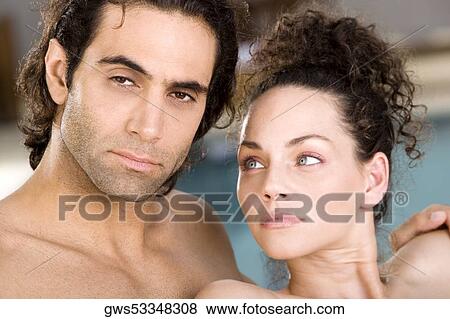 Stock Photo - Portrait of a mid adult man and a young woman at the poolside. Fotosearch