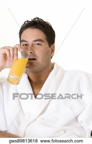 Portrait of a mid adult man drinking a glass of juice View Large Photo Image Stock Photo - Portrait of a mid adult man drinking a glass of juice. Fotosearch