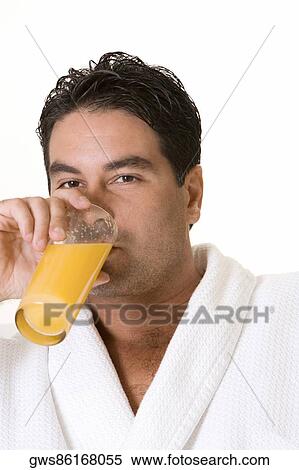 Portrait of a mid adult man drinking a glass of juice View Large Photo Image Stock Photography - Portrait of a mid adult man drinking a glass of juice. Fotosearch