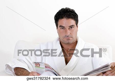 Portrait of a mid adult man holding a newspaper View Large Photo Image Picture - Portrait of a mid adult man holding a newspaper. Fotosearch