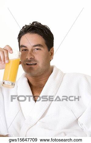 Portrait of a mid adult man holding a glass of juice View Large Photo Image Stock Photo - Portrait of a mid adult man holding a glass of juice. Fotosearch