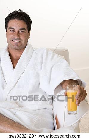 Portrait of a mid adult man holding a glass of juice View Large Photo Image Stock Photo - Portrait of a mid adult man holding a glass of juice. Fotosearch