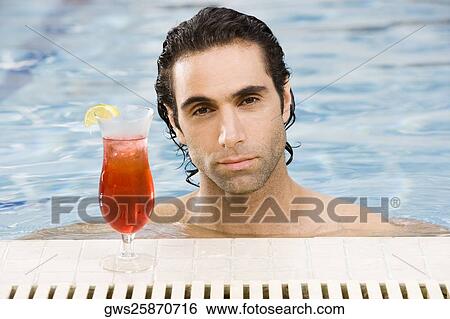 Portrait of a mid adult man in a swimming pool with a cocktail View Large Photo Image Stock Photograph - Portrait of a mid adult man in a swimming pool with a cocktail. Fotosearch