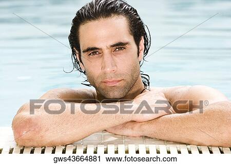 Portrait of a mid adult man leaning at the edge of a swimming pool View Large Photo Image Stock Image - Portrait of a mid adult man leaning at the edge of a swimming pool. Fotosearch
