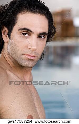 Portrait of a mid adult man sitting near a swimming pool View Large Photo Image Picture - Portrait of a mid adult man sitting near a swimming pool. Fotosearch