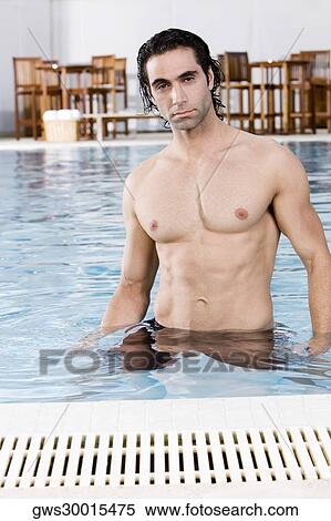 Portrait of a mid adult man standing in a swimming pool View Large Photo Image Stock Photography - Portrait of a mid adult man standing in a swimming pool. Fotosearch