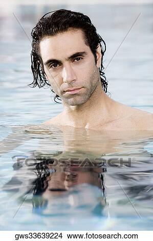 Picture - Portrait of a mid adult man swimming in a swimming pool. Fotosearch