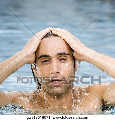 Portrait of a mid adult man swimming in a swimming pool View Large Photo Image Stock Image - Portrait of a mid adult man swimming in a swimming pool. Fotosearch