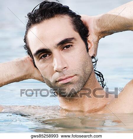 Portrait of a mid adult man swimming in a swimming pool View Large Photo Image Stock Image - Portrait of a mid adult man swimming in a swimming pool. Fotosearch