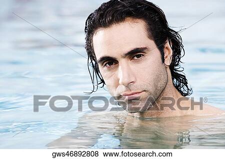 Portrait of a mid adult man swimming in a swimming pool View Large Photo Image Stock Photo - Portrait of a mid adult man swimming in a swimming pool. Fotosearch