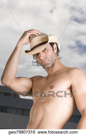 Portrait of a mid adult man wearing a hat View Large Photo Image Stock Photograph - Portrait of a mid adult man wearing a hat. Fotosearch