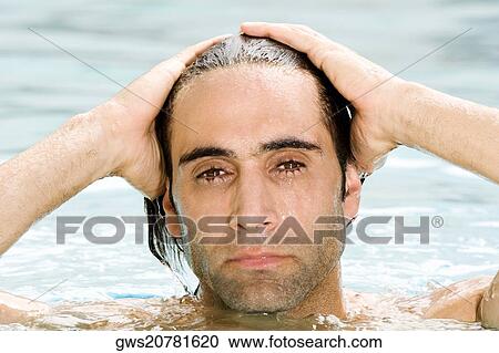 Portrait of a mid adult man with his hands on his head in a swimming pool View Large Photo Image Stock Image - Portrait of a mid adult man with his hands on his head in a swimming pool. Fotosearch