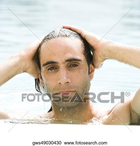 Portrait of a mid adult man with his hands on his head in a swimming pool View Large Photo Image Stock Image - Portrait of a mid adult man with his hands on his head in a swimming pool. Fotosearch
