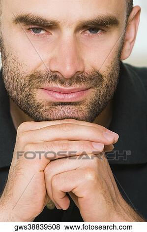 Portrait of a mid adult man with his hands under his chin View Large Photo Image Stock Photo - Portrait of a mid adult man with his hands under his chin. Fotosearch