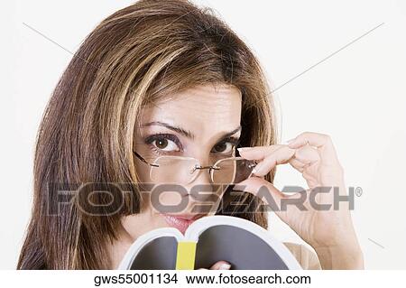 Portrait of a mid adult woman adjusting her eyeglasses View Large Photo Image Picture - Portrait of a mid adult woman adjusting her eyeglasses. Fotosearch