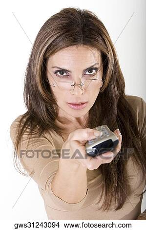 Picture - Portrait of a mid adult woman holding a remote control. Fotosearch
