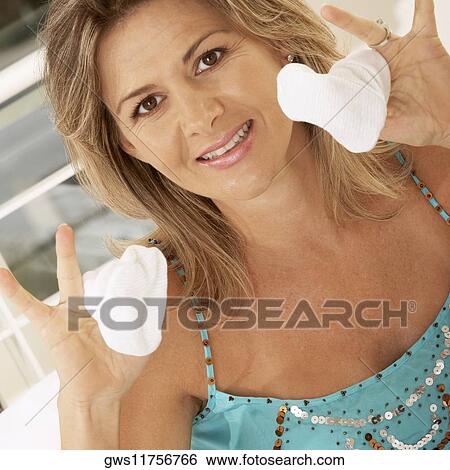 Portrait of a mid adult woman holding baby socks View Large Photo Image Stock Photograph - Portrait of a mid adult woman holding baby socks. Fotosearch