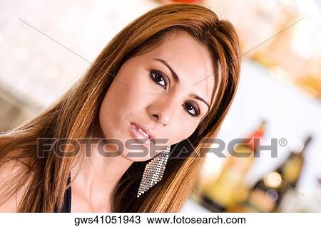 Stock Image - Portrait of a mid adult woman looking serious. Fotosearch