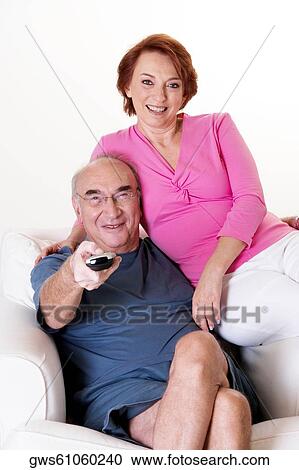Portrait of a senior couple watching television View Large Photo Image Stock Image - Portrait of a senior couple watching television. Fotosearch