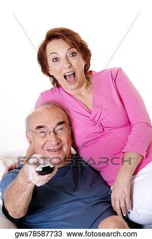 Portrait of a senior couple watching television View Large Photo Image Stock Image - Portrait of a senior couple watching television. Fotosearch