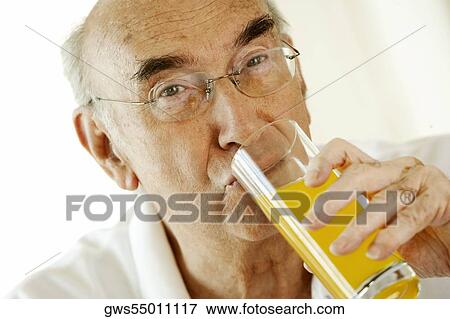 Portrait of a senior man drinking a glass of orange juice View Large Photo Image Stock Photo - Portrait of a senior man drinking a glass of orange juice. Fotosearch