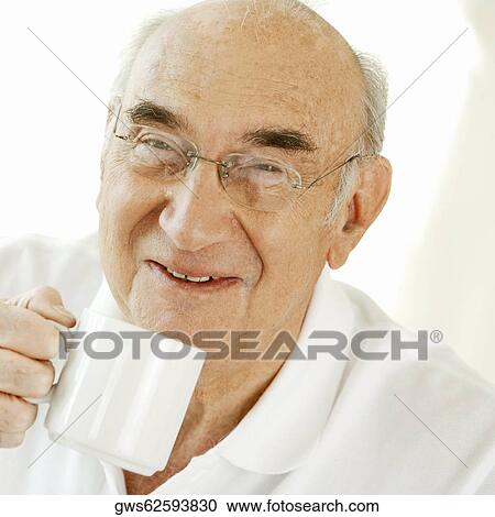 Portrait of a senior man holding a cup of coffee View Large Photo Image Stock Image - Portrait of a senior man holding a cup of coffee. Fotosearch