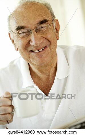 Portrait of a senior man holding a cup of coffee View Large Photo Image Stock Image - Portrait of a senior man holding a cup of coffee. Fotosearch