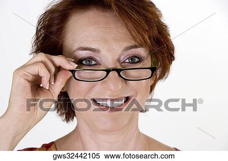 Portrait of a senior woman adjusting her eye glasses View Large Photo Image Stock Photography - Portrait of a senior woman adjusting her eye glasses. Fotosearch