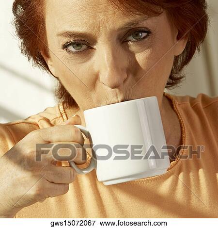 Stock Photo - Portrait of a senior woman drinking a cup of coffee. Fotosearch