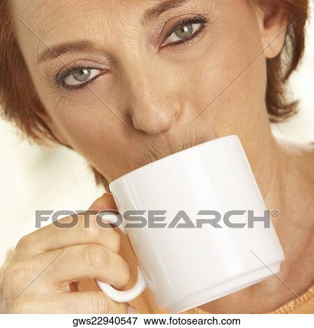 Stock Photo - Portrait of a senior woman drinking a cup of coffee. Fotosearch