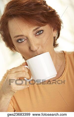 Portrait of a senior woman drinking a cup of coffee View Large Photo Image Stock Photo - Portrait of a senior woman drinking a cup of coffee. Fotosearch