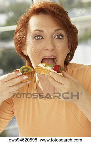 Portrait of a senior woman eating a fruit tart View Large Photo Image Stock Photo - Portrait of a senior woman eating a fruit tart. Fotosearch