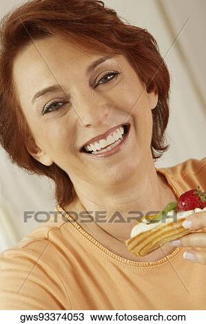 Portrait of a senior woman holding a fruit tart View Large Photo Image Stock Image - Portrait of a senior woman holding a fruit tart. Fotosearch