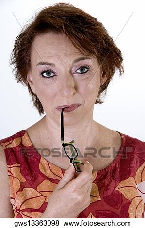 Portrait of a senior woman holding eyeglasses View Large Photo Image Stock Photo - Portrait of a senior woman holding eyeglasses. Fotosearch