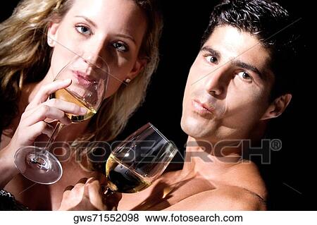 Portrait of a young couple drinking wine View Large Photo Image Stock Photo - Portrait of a young couple drinking wine. Fotosearch