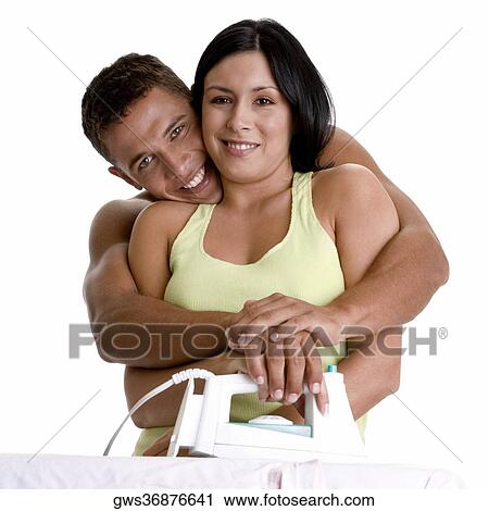 Portrait of a young couple ironing on an ironing board View Large Photo Image Stock Image - Portrait of a young couple ironing on an ironing board. Fotosearch