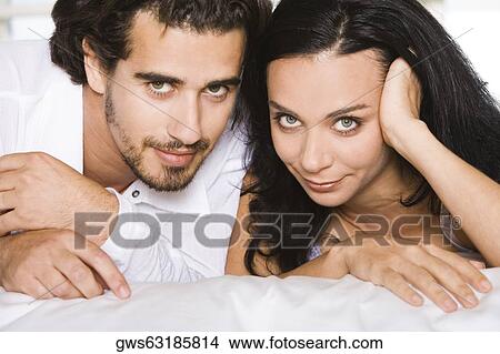 Portrait of a young couple lying down View Large Photo Image Picture - Portrait of a young couple lying down. Fotosearch