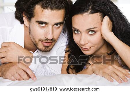 Portrait of a young couple lying down View Large Photo Image Stock Photo - Portrait of a young couple lying down. Fotosearch