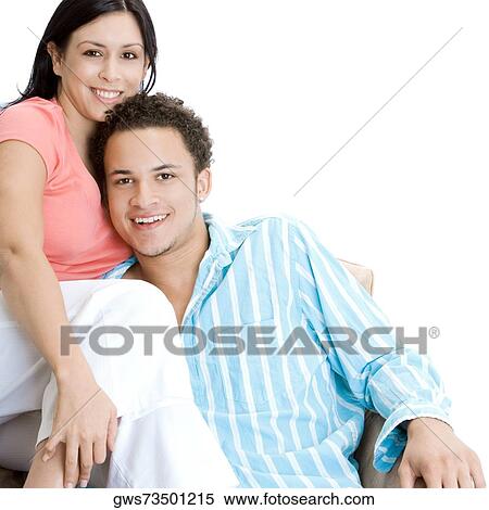 Portrait of a young couple sitting on an armchair View Large Photo Image Stock Photography - Portrait of a young couple sitting on an armchair. Fotosearch