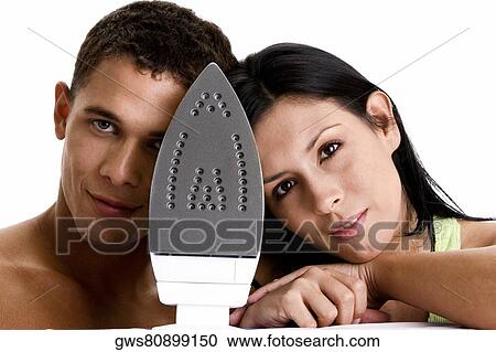 Portrait of a young couple with an iron in front of them View Large Photo Image Stock Image - Portrait of a young couple with an iron in front of them. Fotosearch
