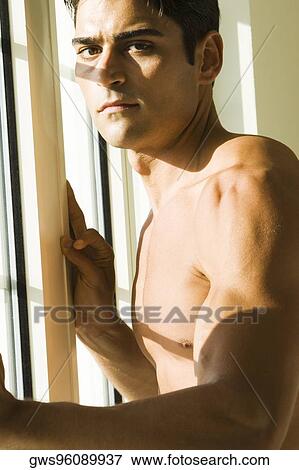 Stock Photo - Portrait of a young looking serious. Fotosearch