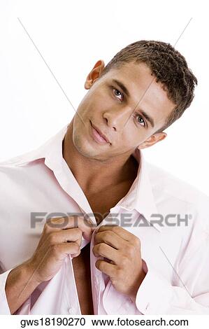 Portrait of a young man buttoning his shirt View Large Photo Image Stock Image - Portrait of a young man buttoning his shirt. Fotosearch