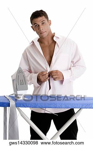 Stock Photo - Portrait of a young man buttoning his shirt. Fotosearch