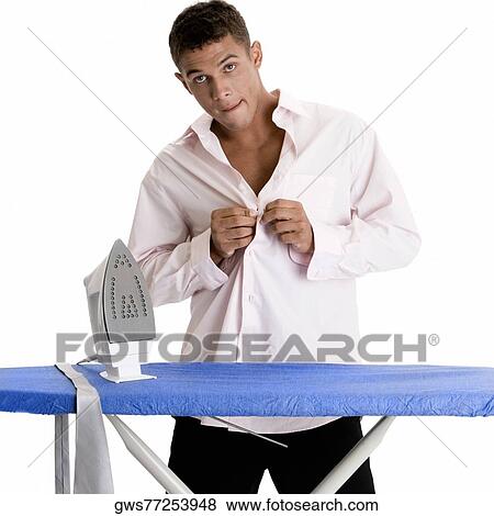 Portrait of a young man buttoning his shirt View Large Photo Image Stock Photo - Portrait of a young man buttoning his shirt. Fotosearch