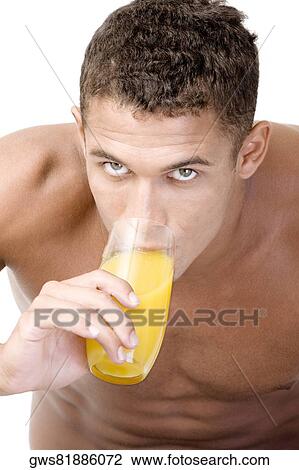 Portrait of a young man drinking a glass of juice View Large Photo Image Stock Image - Portrait of a young man drinking a glass of juice. Fotosearch