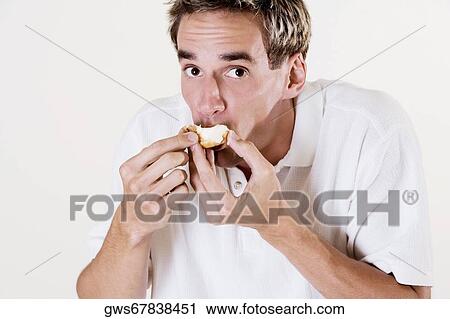 Portrait of a young man eating a strawberry tart View Large Photo Image Stock Image - Portrait of a young man eating a strawberry tart. Fotosearch