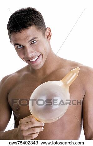 Portrait of a young man holding a blown condom View Large Photo Image Stock Image - Portrait of a young man holding a blown condom. Fotosearch